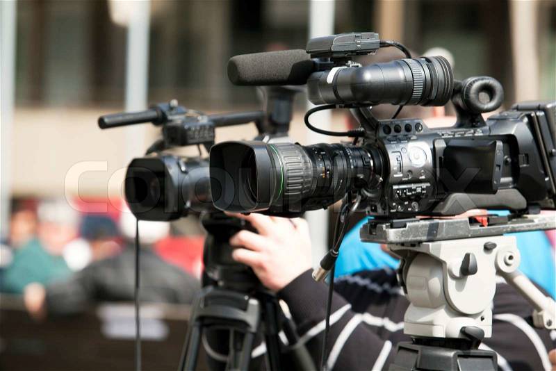 Covering an event with a video camera, stock photo