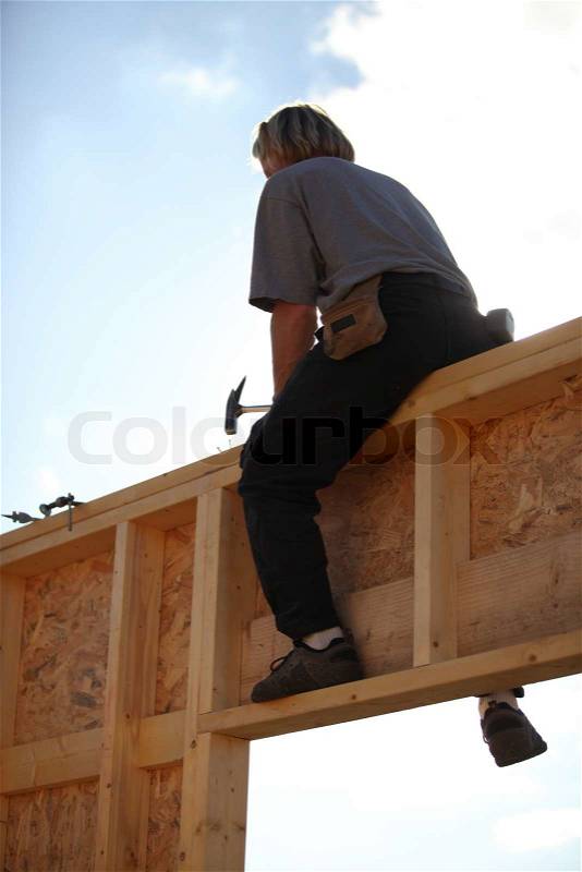 Woodworker on a construction site, stock photo