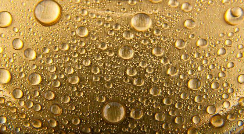 Drops of water on a gold background, stock photo