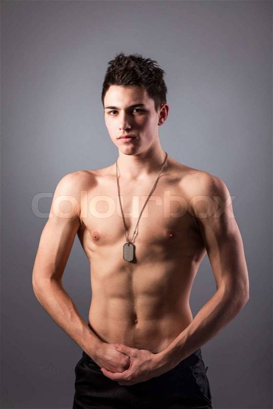 Portrait of young bodybuilder man on a black background, stock photo