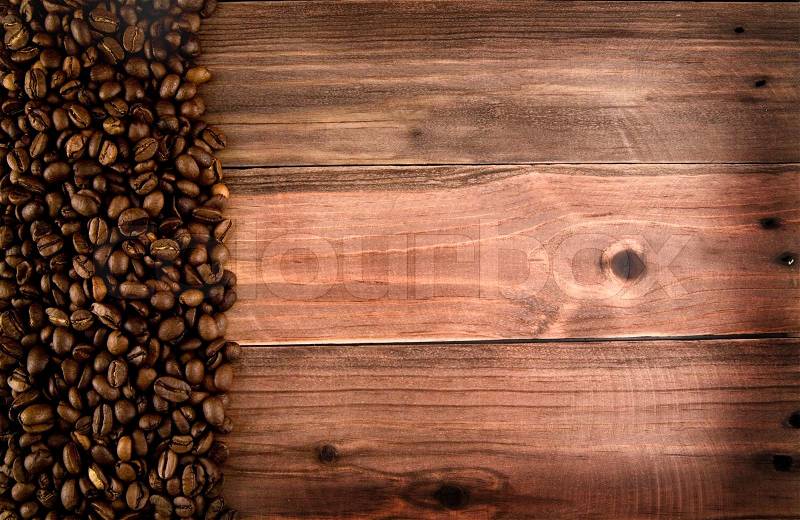 Grains of coffee on a wooden table, stock photo