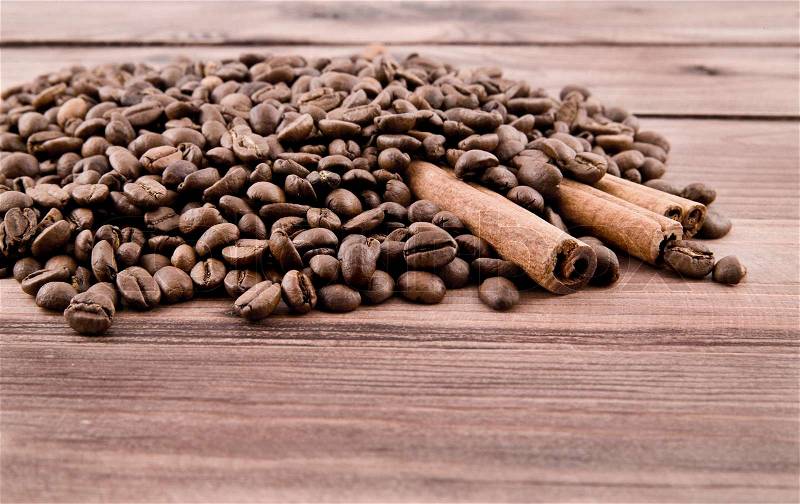 Grains of coffee on a wooden table , stock photo