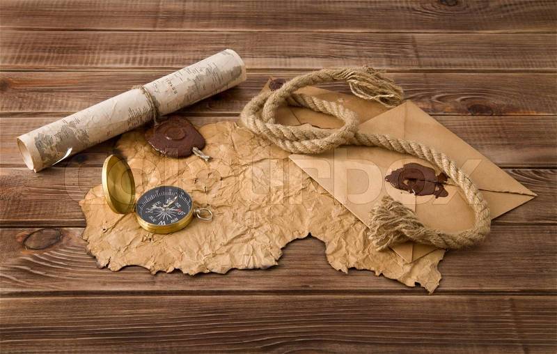 Map and compass on a wooden background , stock photo