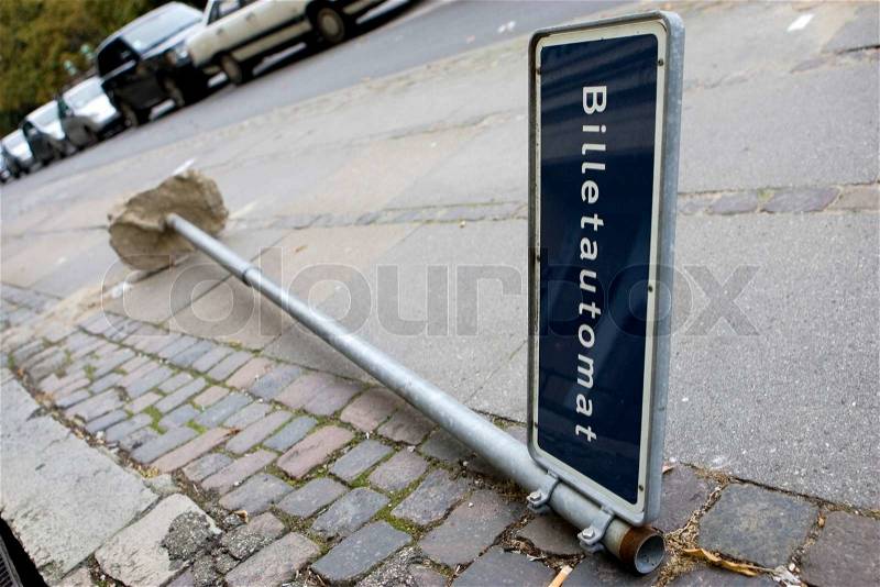A broken ticketing sign pole on the ground, stock photo