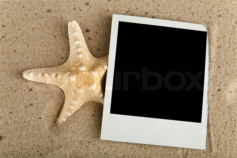 Starfish and picture on sand, stock photo