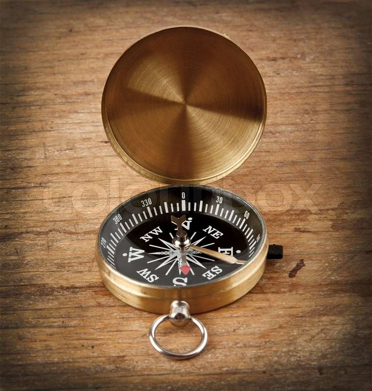 Compass on a wooden background, stock photo