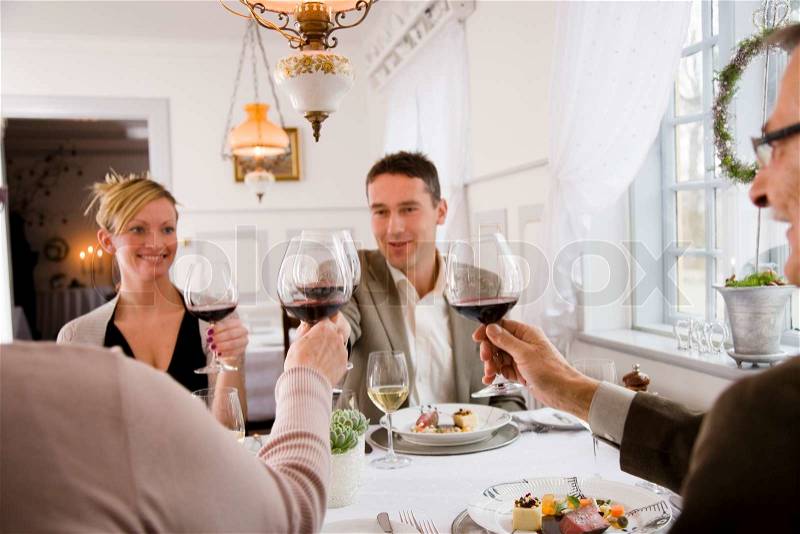 Restaurant guests toasting before dinner, stock photo