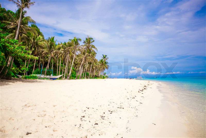 Beautiful wild white beach at remote tropical island, stock photo