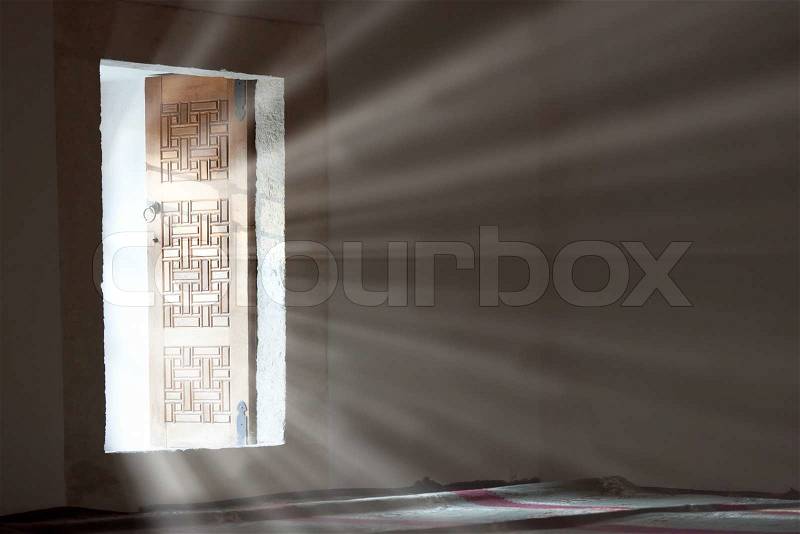 Light entering through open door to a dark empty room. , stock photo