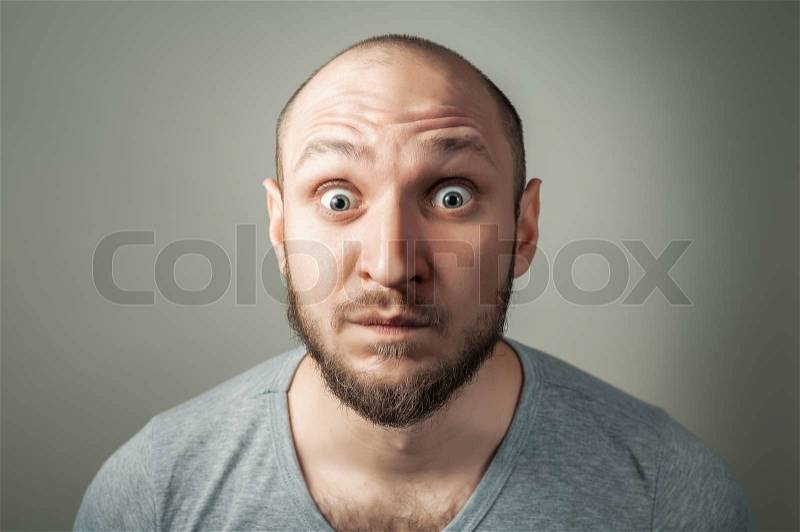 Handsome young man making funny faces, stock photo