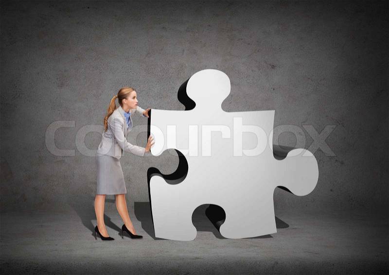 Business, post and transportation concept - busy businesswoman pushing puzzle piece, stock photo