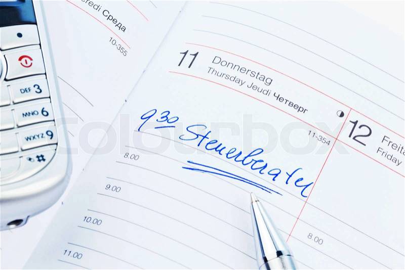 A date is entered on a calendar: tax consultants, stock photo