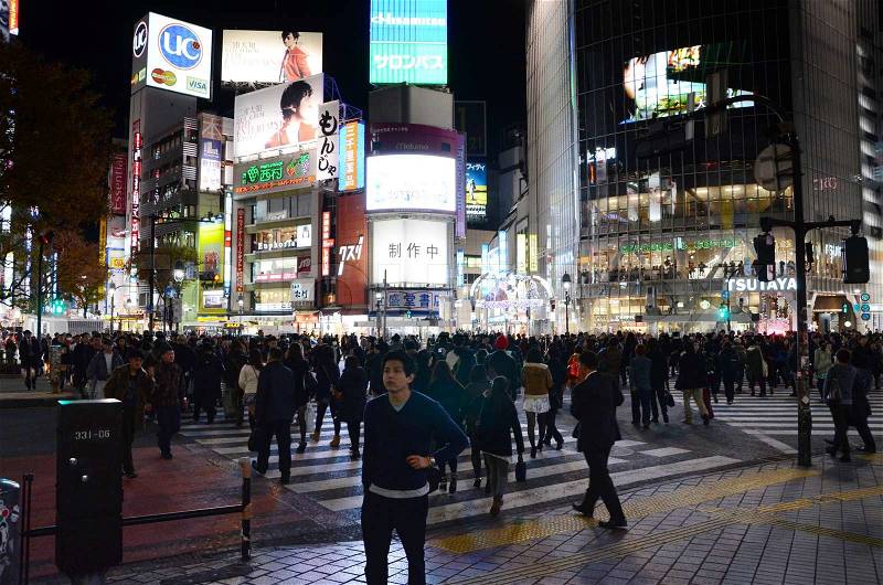 TOKYO - NOVEMBER 28: Pedestrians at the famed crossing of Shibuya district November 28, 2013 in Tokyo, JP. Shibuya is a fashion center and nightlife area. , stock photo