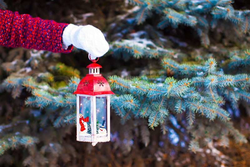Closeup of a hand holding beautiful vintage Christmas lantern, stock photo