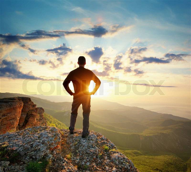 Man on top of mountain. Conceptual scene, stock photo