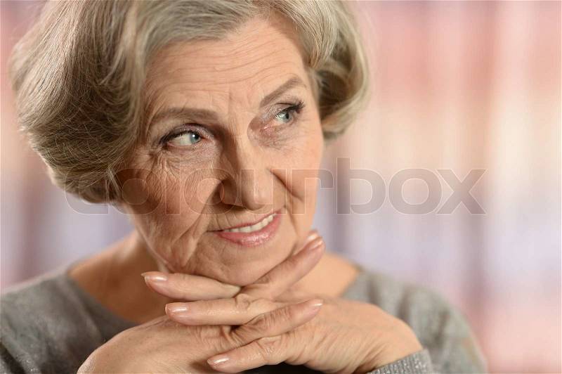 Close-up portrait of a happy older woman at home, stock photo
