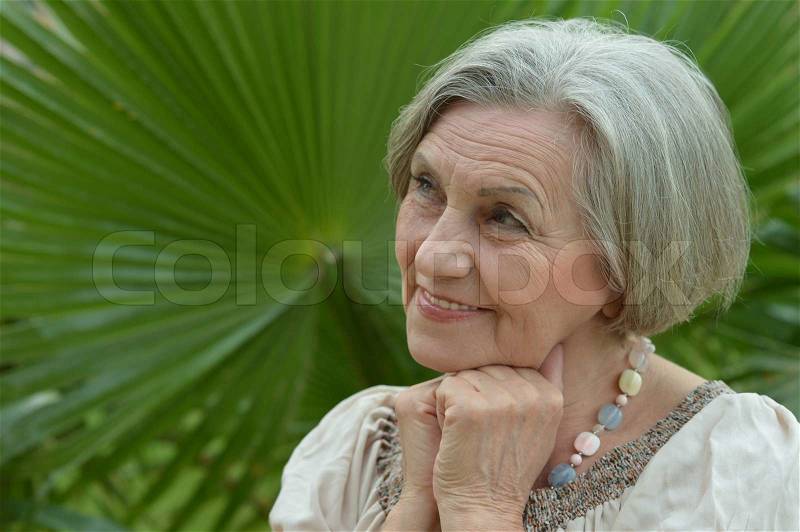 Nice woman went to a resort vacation with palm trees, stock photo