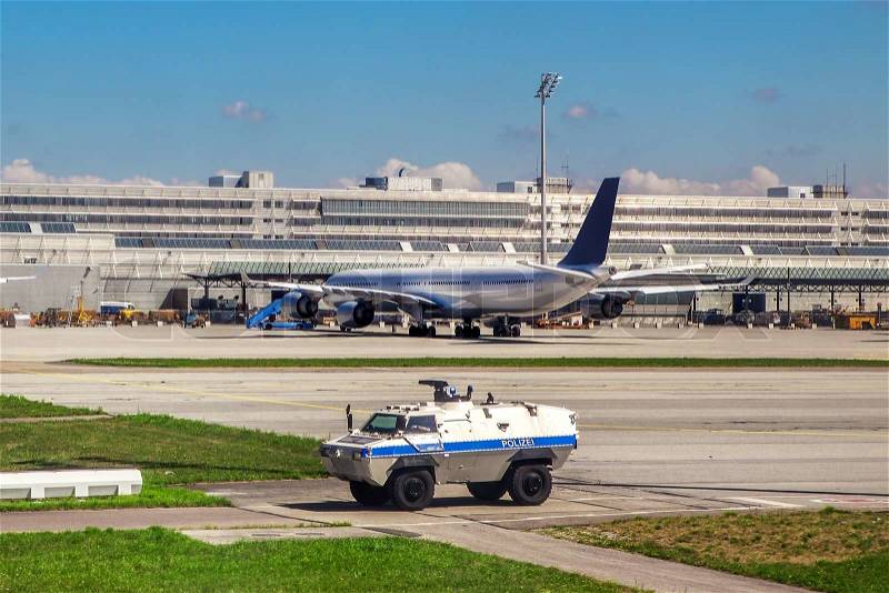 Police security vehicle patrols outdoor perimeter of Munich International Airport, stock photo