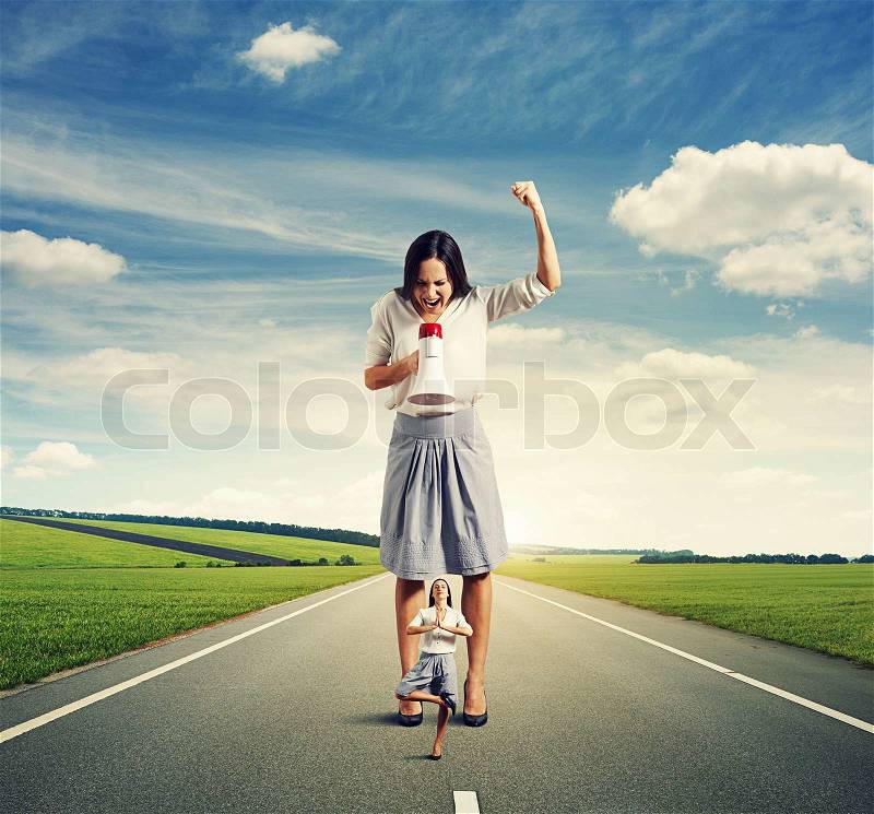 Dissatisfied woman and calm yoga woman on the road, stock photo
