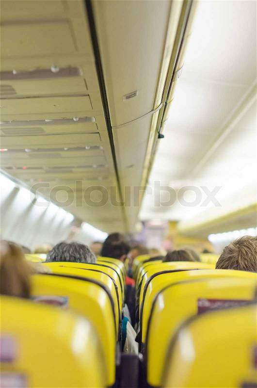 Interior inside of the plane with passengers, stock photo