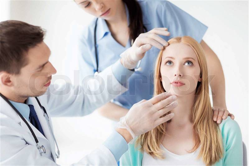 Bright picture of male plastic surgeon with patient, stock photo