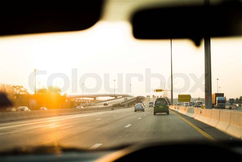 Vision of cars and road through driver\'s eyes with blur console as foreground, stock photo