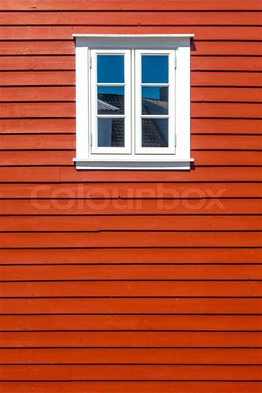 White wooden window on the traditional red wooden house wall, Norway, with copy space, stock photo