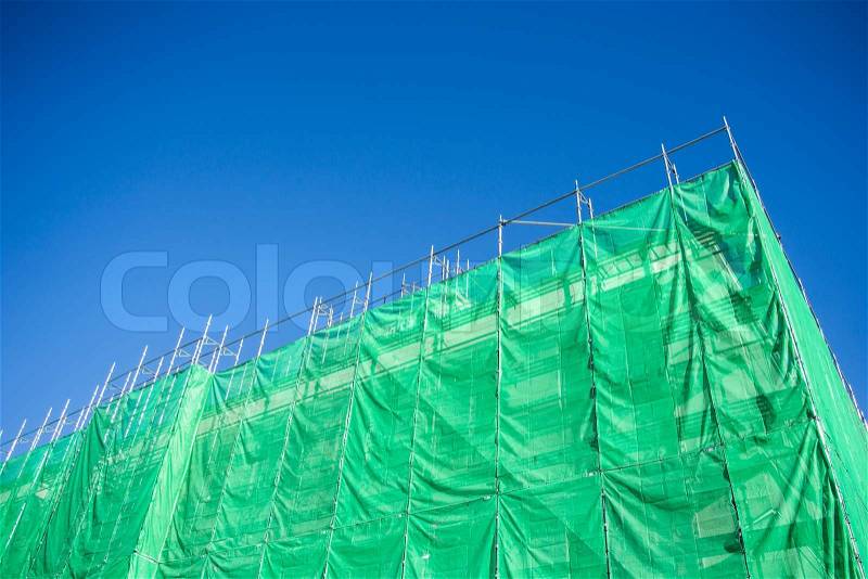 Green cloth cover on building construction site, stock photo