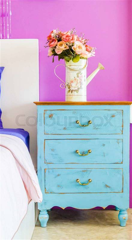 Interior bed room vase flower on wood beside bed table, stock photo