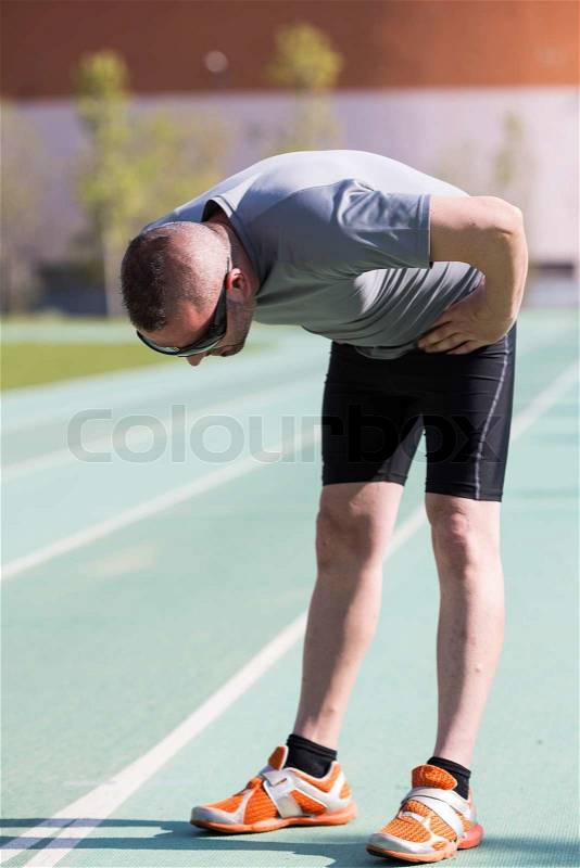Sportsman fatigued after seeing traveled a long distance, stock photo