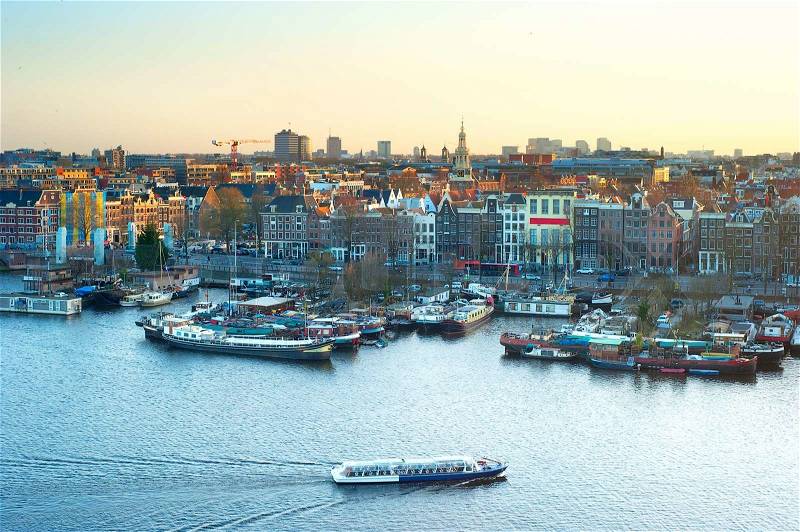 Cityscape of Amsterdam at colorful sunset. Aerial view, stock photo