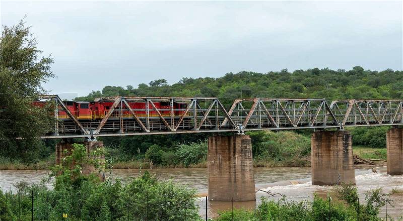 Train crossing bridge over elephant riverin south africa near the palce hoedspruit, stock photo
