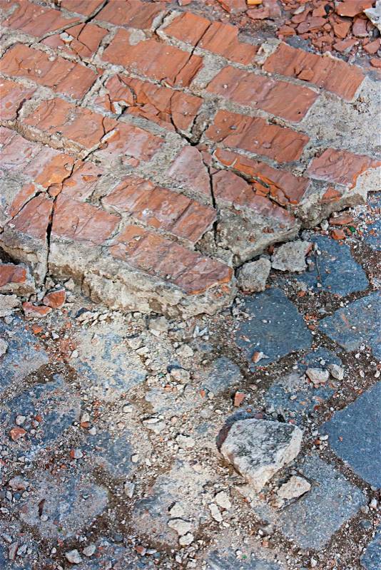 Wall cracked, bricks on the floor, cobblestones, stock photo
