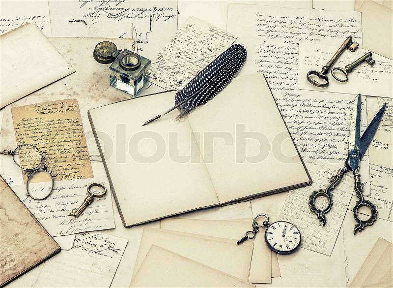 Open diary book, antique accessories, old letters, inkwell and vintage feather ink pen. retro style toned picture, stock photo