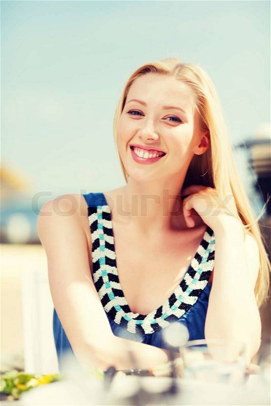 Summer holidays and vacation - girl in cafe on the beach, stock photo