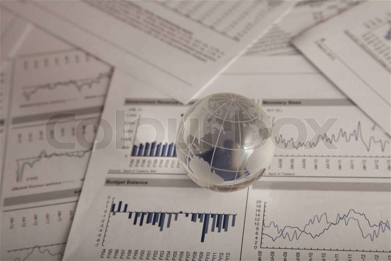 Glass globe on the chart papers, stock photo