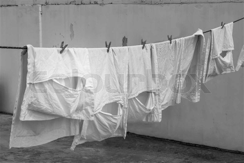 Image Monochrome clothes white hanging to dry on a laundry line, stock photo