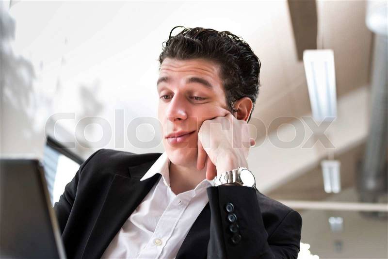 Business man bored in front of his computer, stock photo