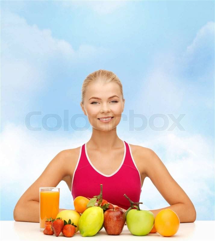 Fitness, healthcare and diet concept - smiling young woman with organic food or fruits on table, stock photo