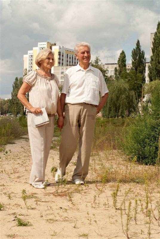 Charming elderly couple went for a walk on spring day, stock photo