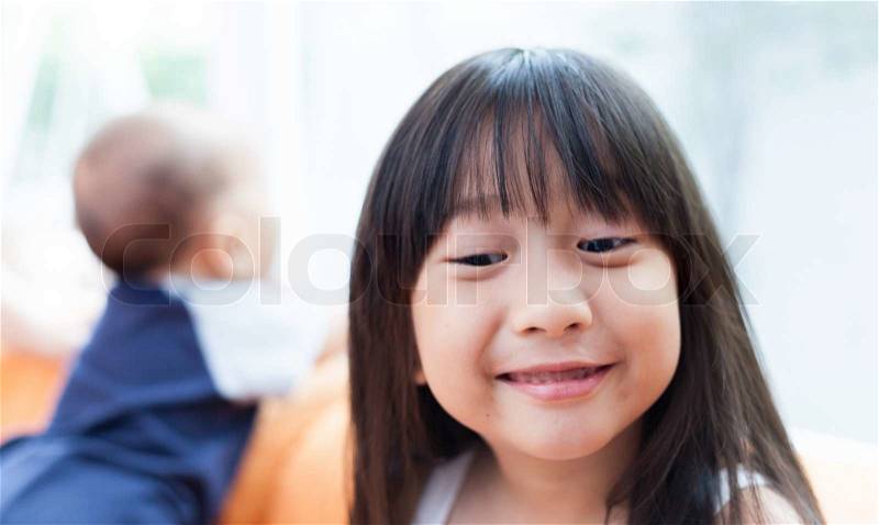 Girl making a funny face.\'s The Asian woman with long black hair, stock photo