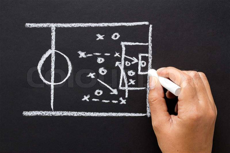 Hand drawing a soccer strategy chart with chalk, stock photo