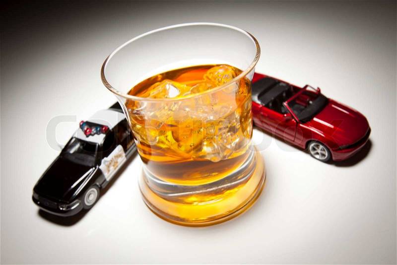 Police and Sports Car Next to Alcoholic Drink Under Spot Light, stock photo