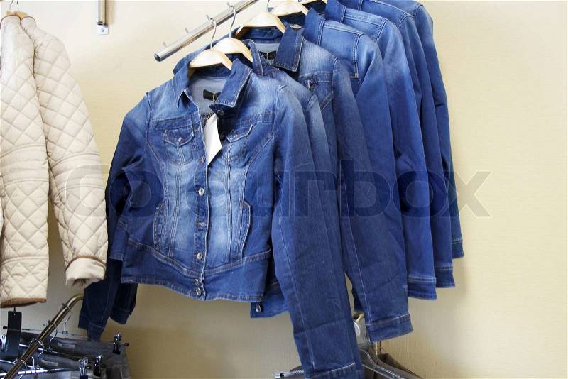 Denim jackets hanging in the shop for sale, stock photo