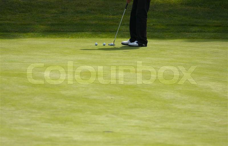 Golfer Putting on the Green one Summer Day, stock photo