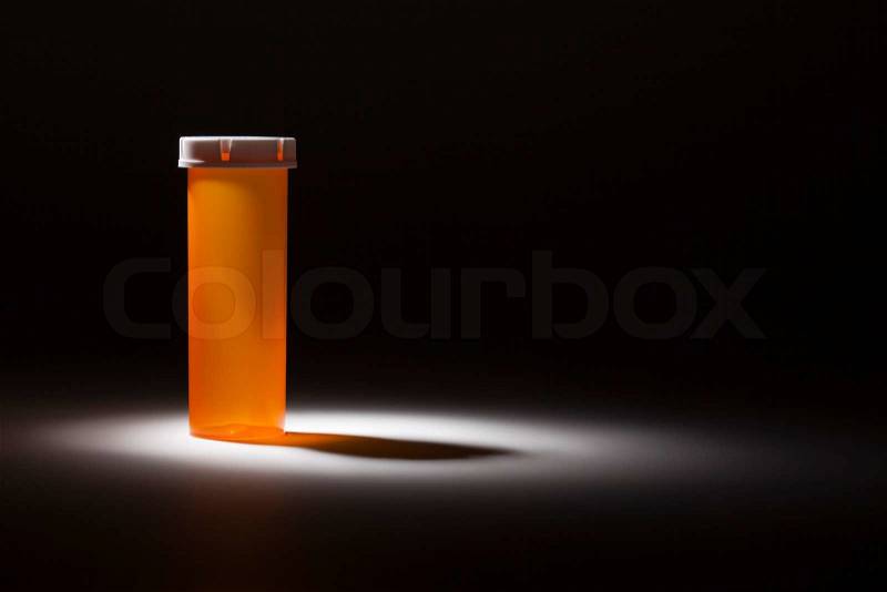 Empty Medicine Bottle Under Spot Light Abstract, stock photo