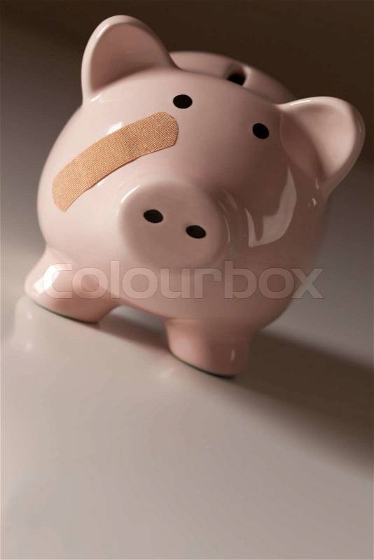 Piggy Bank with Bandage on Face on Gradated Background, stock photo
