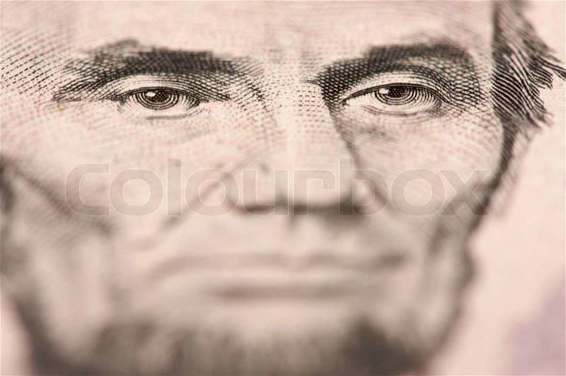 Abstract Macro of U.S. Five Dollar Bill\'s Abraham Lincoln face with Narrow Depth of Field, stock photo