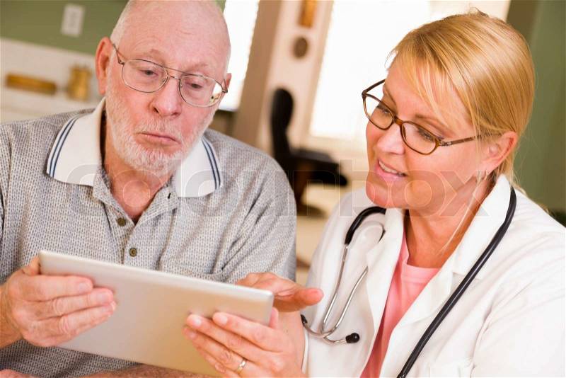 Doctor or Nurse Talking to Senior Man with Touch Pad Computer, stock photo