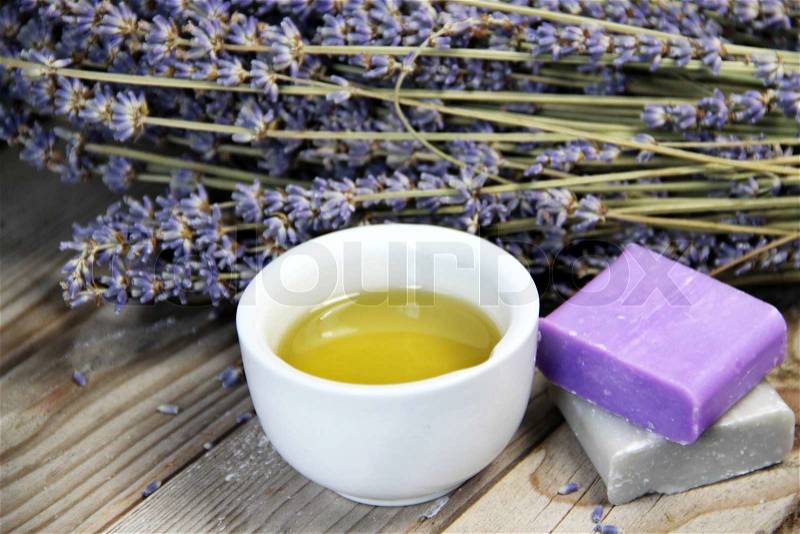 Mix of lavender flowers and cosmetic on the wooden background , stock photo